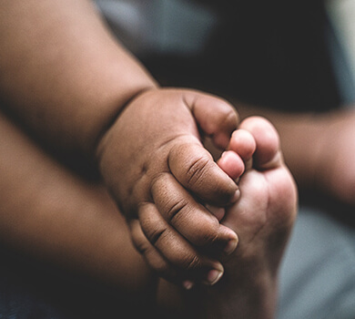 Baby holding their feet